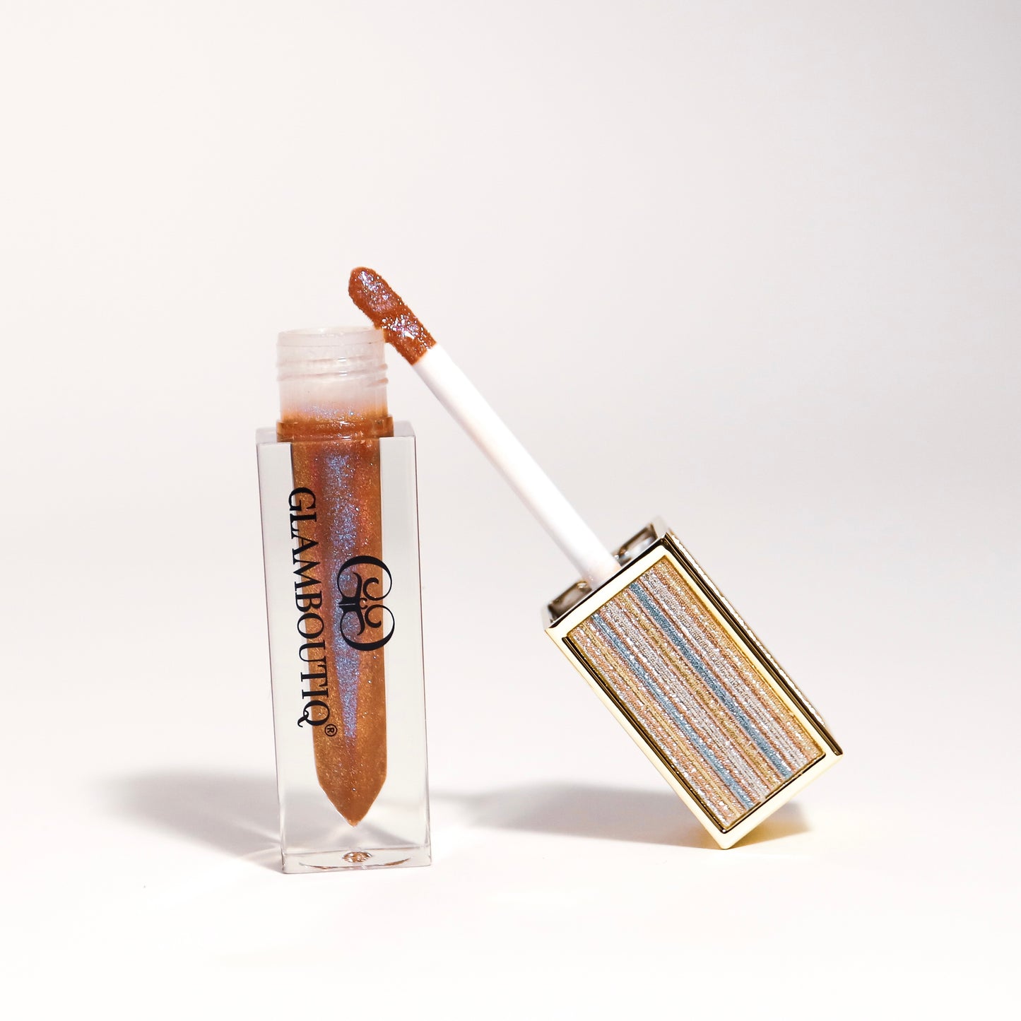 Lipgloss in a bold Doll Drama shade for a dramatic, high-shine finish